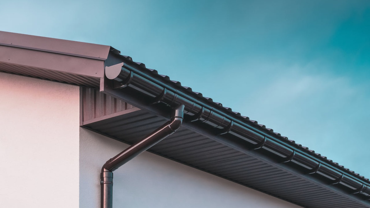 Guttering and downpipe installation on a UK building
